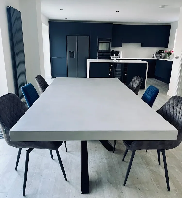 Slimline polished concrete dining table with clean minimalist profile and steel base