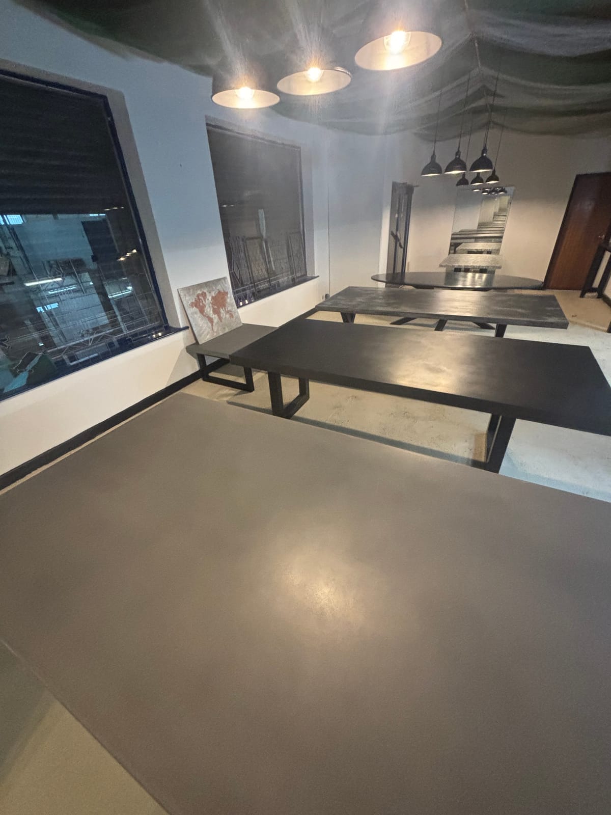 Polished concrete dining table displayed in Stockport showroom
