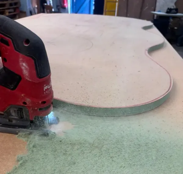 Oval polished concrete dining table with curved ends and welded steel base