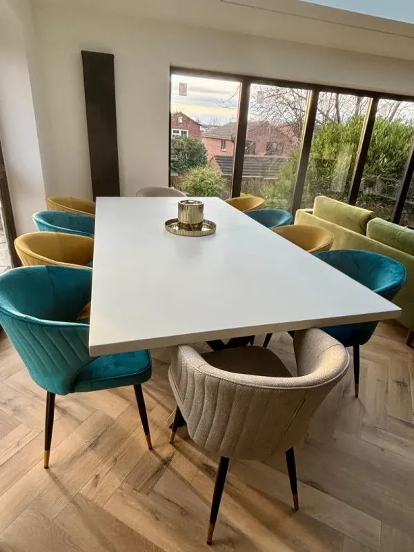 White polished concrete dining table with light-toned surface and welded steel base