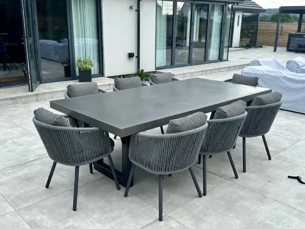Dark grey polished concrete dining table with sealed concrete surface and welded steel base