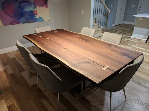 Live edge solid wood dining table with black resin infills and box steel base